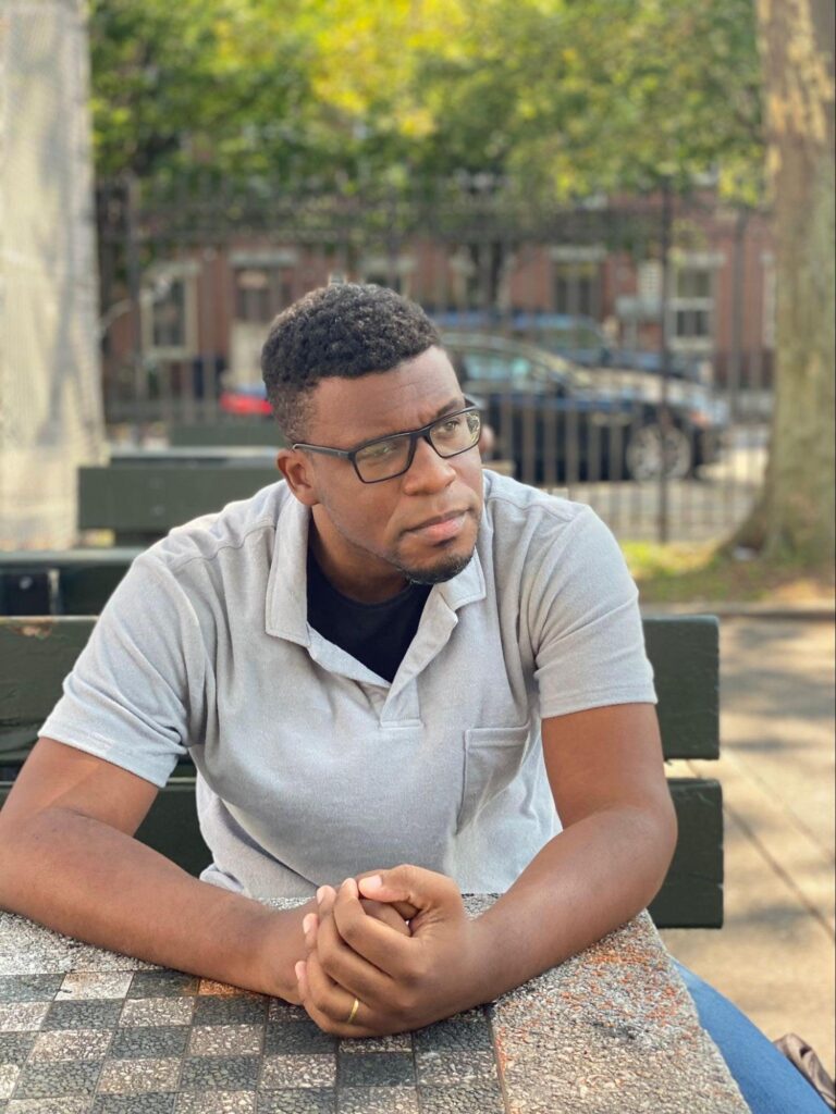 Image of Marcello Correa sitting in a park in Bedford-Stuyvesant, Brooklyn